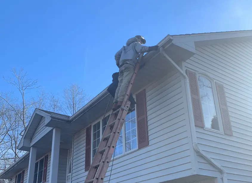 Gutter cleaning and maintenance being performed by Cuyahoga Falls Power Washing in Cuyahoga Falls